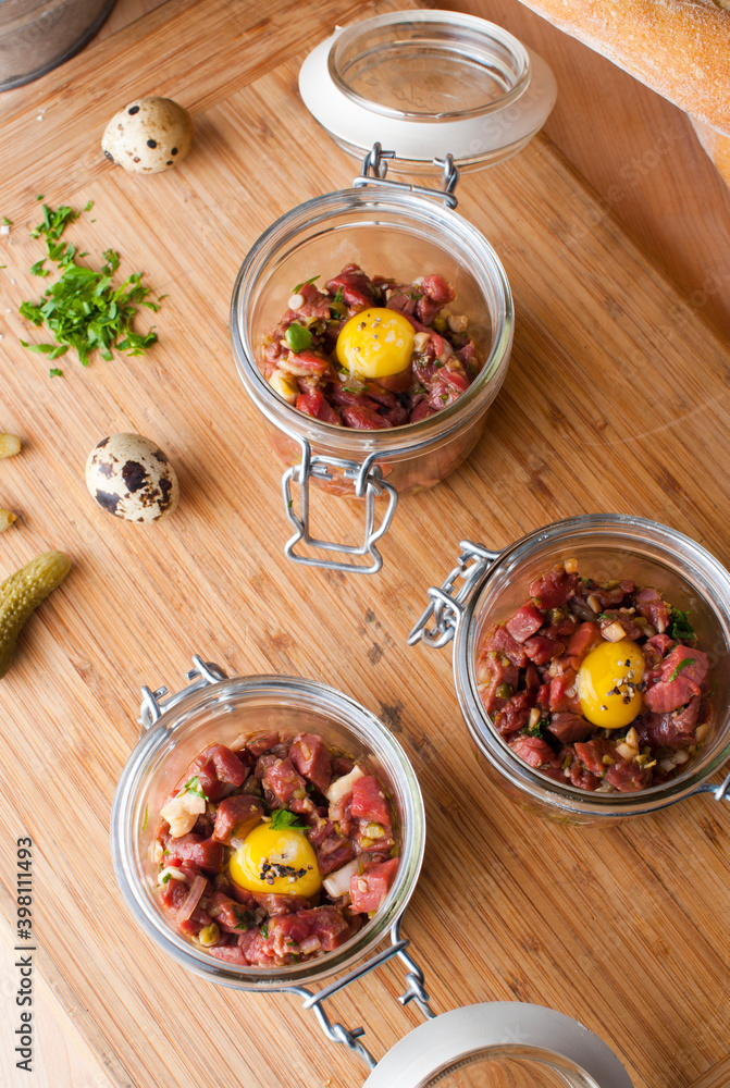 Steak tartare. Classic American restaurant or French bistro appetizer classic. Steak diced, mixed with eggs, red onions, olive oil, lemon juice, garlic and capers. Served with garlic bread. Steak tartare. Classic American restaurant or French bistro appetizer classic. Steak diced, mixed with eggs, red onions, olive oil, lemon juice, garlic and capers. Served with garlic bread.