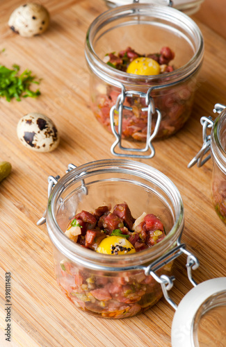 Steak tartare. Classic American restaurant or French bistro appetizer classic. Steak diced, mixed with eggs, red onions, olive oil, lemon juice, garlic and capers. Served with garlic bread.