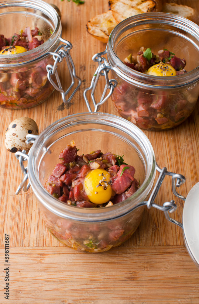 Steak tartare. Classic American restaurant or French bistro appetizer classic. Steak diced, mixed with eggs, red onions, olive oil, lemon juice, garlic and capers. Served with garlic bread. Steak tartare. Classic American restaurant or French bistro appetizer classic. Steak diced, mixed with eggs, red onions, olive oil, lemon juice, garlic and capers. Served with garlic bread.