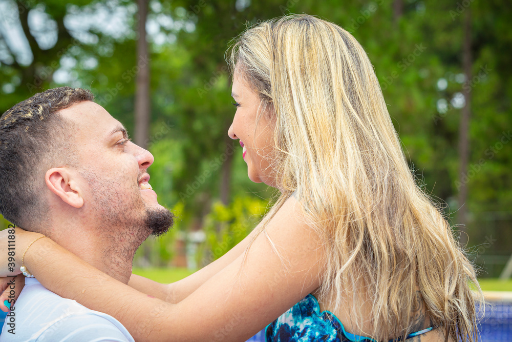 Couple inside the pool looking at each other. Couple inside the pool looking at each other.