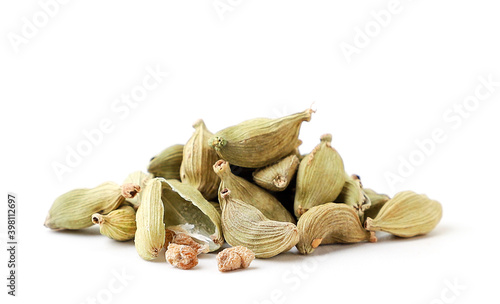 Pile of cardamom and a broken one close up on a white background. Isolated photo