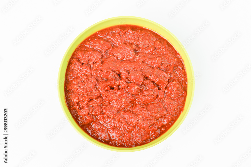 Top view of grinded chili pepper in a green bowl isolated on a white background. Top view of grinded chili pepper in a green bowl isolated on a white background.