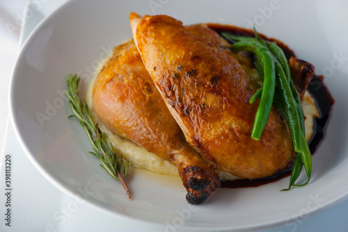 Chicken pan seared in garlic, butter, shallots and white wine. Classic fine dining cuisine. Served with steamed vegetables, broccoli carrots cauliflower, garnished with lemons and Italian parsley.