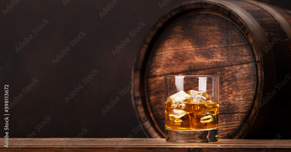 Scotch whiskey glass and old wooden barrel Scotch whiskey glass and old wooden barrel