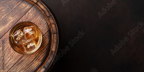 Scotch whiskey glass and old barrel