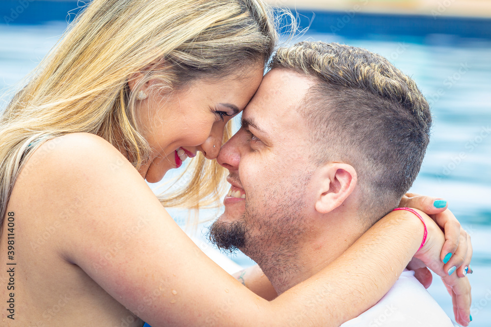 Close up of couple near the pool, with face glued, and smiling. Close up of couple near the pool, with face glued, and smiling.