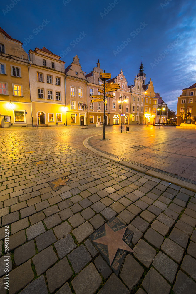 Night view of the market square in Opole with a historic fountain