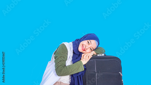 Portrait of a cheerful young asian  woman wearing hijab - traveling concept © Rizky