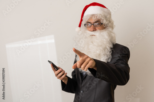 santa laughs and shows a finger on a white background