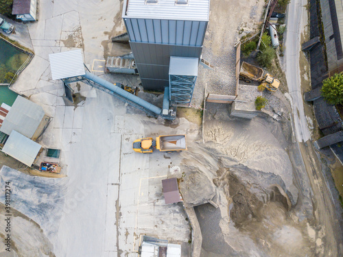 Aerial view of dumper truck in industrial pit for rock and sand mining. © Mario