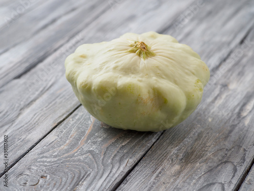 Pattypan squash on old rustic wooden background. photo