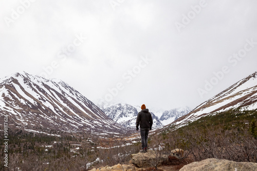 Male hiker admires the landscape of Chugach State Park, Alaska