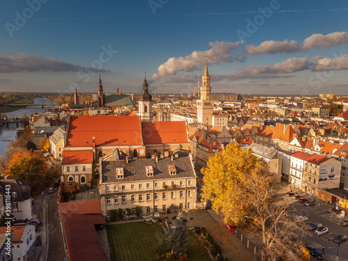 A drone view of the historic city with the market square, churches, town hall and the castle tower in Opole during sunset. Autumn in Silesia - Poland.