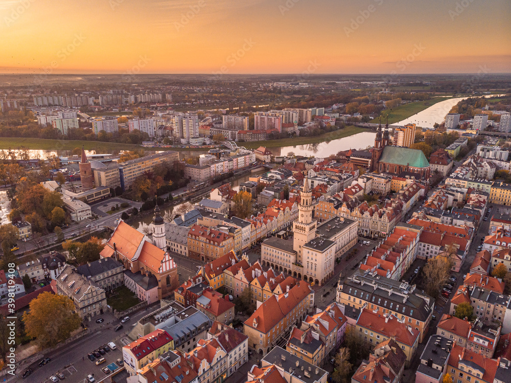 A drone view of the historic city with the market square, churches and the town hall in Opole during sunset. Autumn in Silesia - Poland.