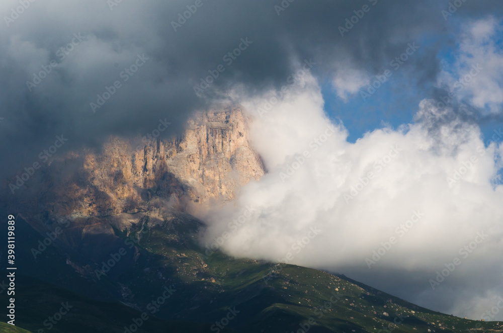 Mountain top in thunderstorm clouds