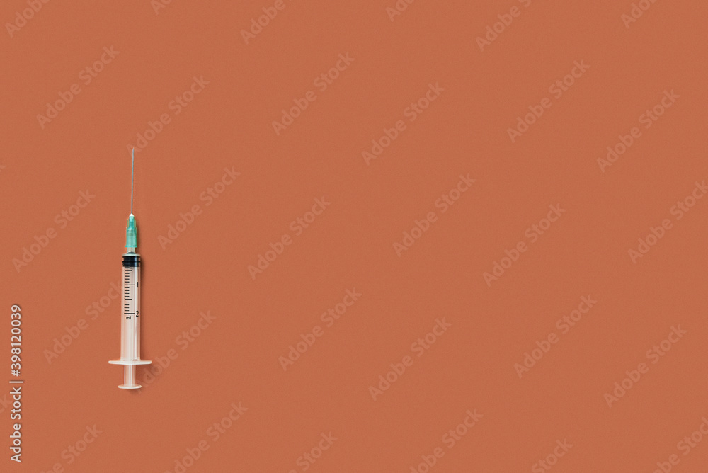 Vaccine syringe isolated on orange background. copyspace Vaccine syringe isolated on orange background. copyspace
