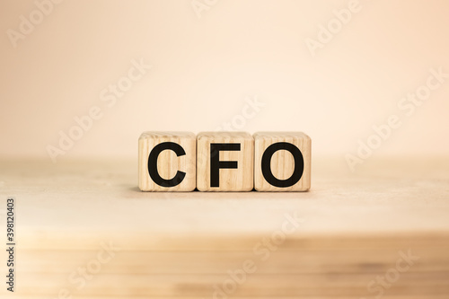 Word CFO Chief Financial Officer on wooden blocks beige background