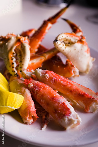 King crab or Dungeness legs . Jumbo Crab served with lemons, spicy rémoulade sauce on top of a mixed green salad. Classic American restaurant or steakhouse appetizer or entree.
