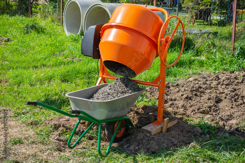 ready-mixed concrete discharged into a cart from a 200 liter electric concrete mixer