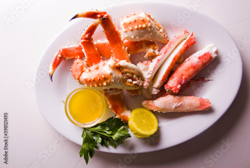 King crab or Dungeness legs . Jumbo Crab served with lemons, spicy rémoulade sauce on top of a mixed green salad. Classic American restaurant or steakhouse appetizer or entree.