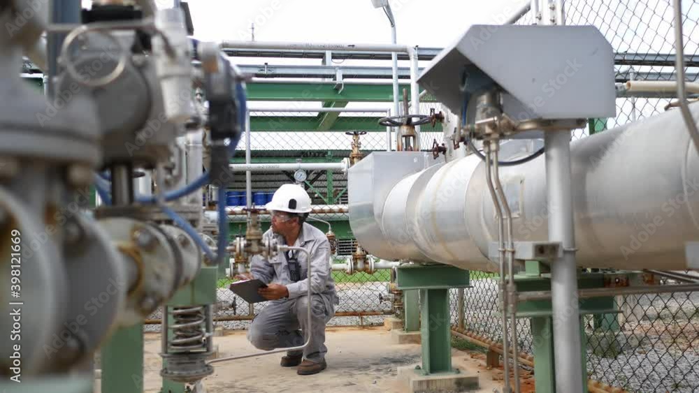 Field workers are inspecting the equipment, measuring and control equipment of the supply station for the industrial plant. Petroleum oil and refinery plant Field workers are inspecting the equipment, measuring and control equipment of the supply station for the industrial plant. Petroleum oil and refinery plant