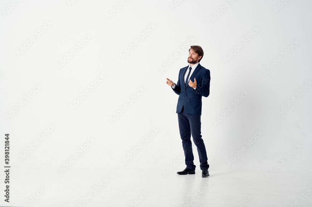 business man in a classic suit in full growth on a light background business man in a classic suit in full growth on a light background