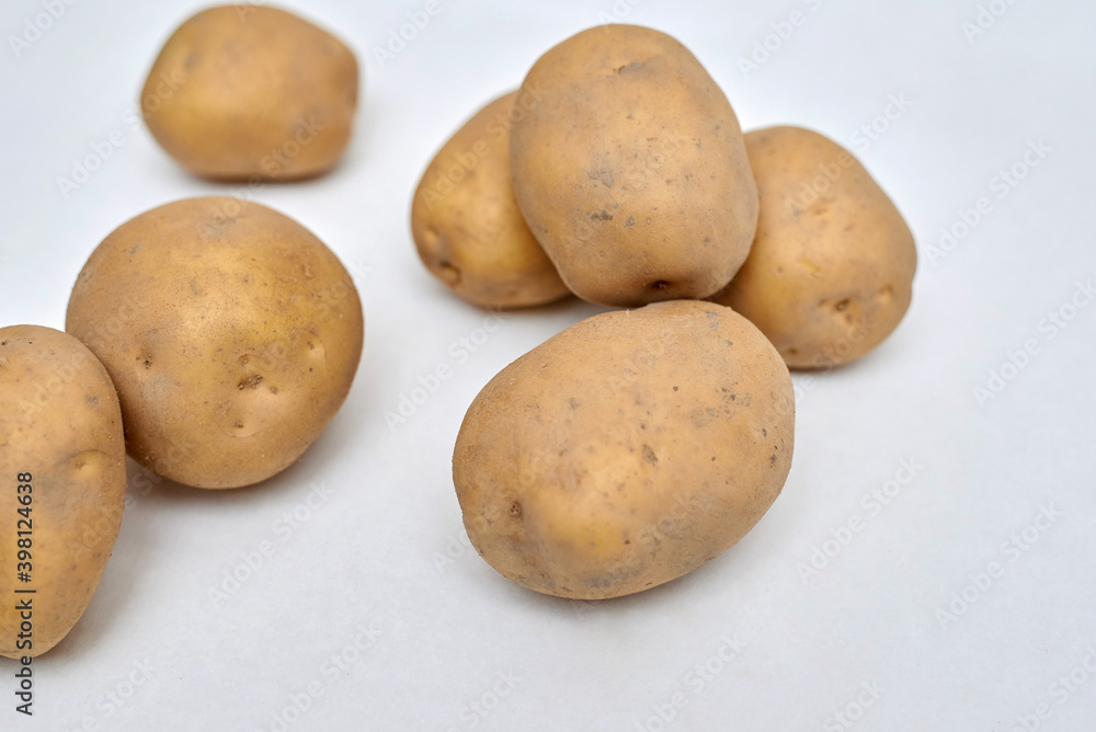 fresh unpeeled potatoes on a white background fresh unpeeled potatoes on a white background