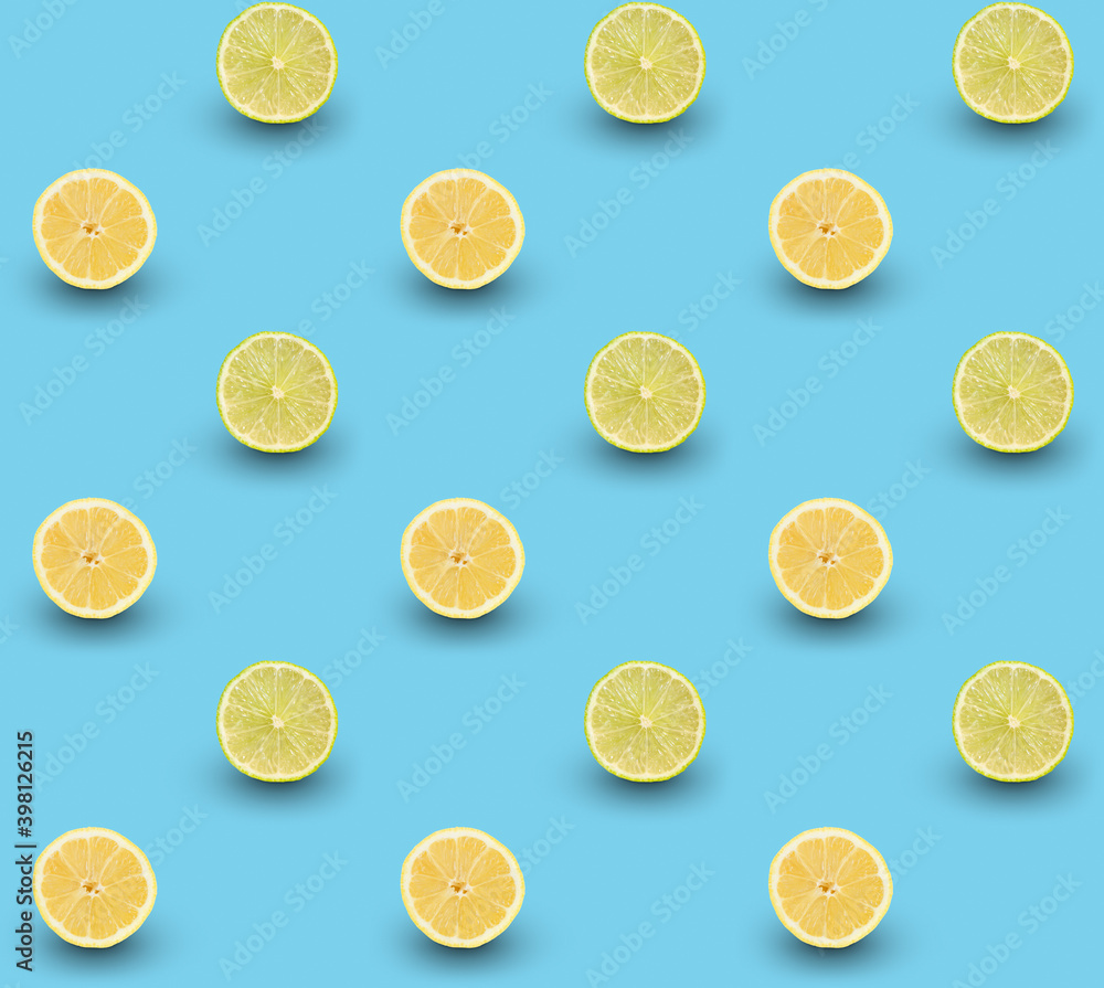 Repeated seamless pattern of many sliced ripe lemons and limes on light blue background.