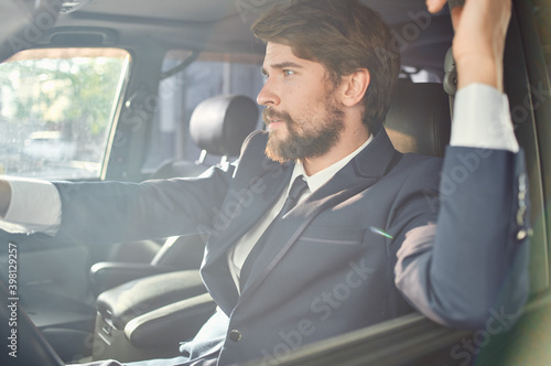 rich man in suit driving a car trip fun lifestyle © SHOTPRIME STUDIO