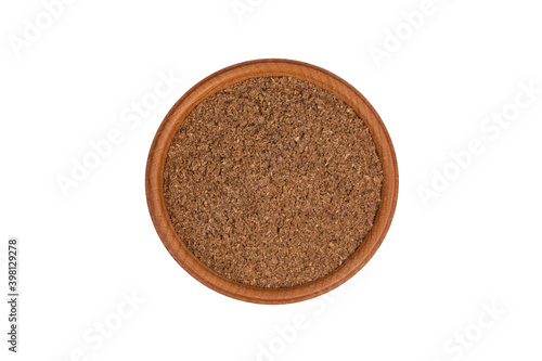 Coriander powder in wooden bowl isolated on white