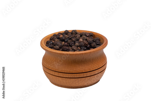 Black peppercorns in wooden bowl isolated on white