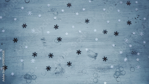 White and silver snowflakes falling on blue background
