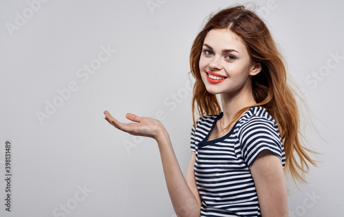emotional woman with bright makeup gesturing with hands on gray background Copy Space