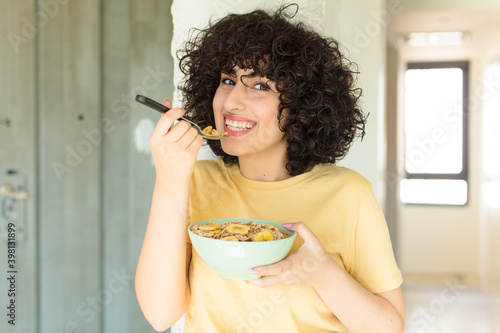 young pretty woman having breakfast at home photo