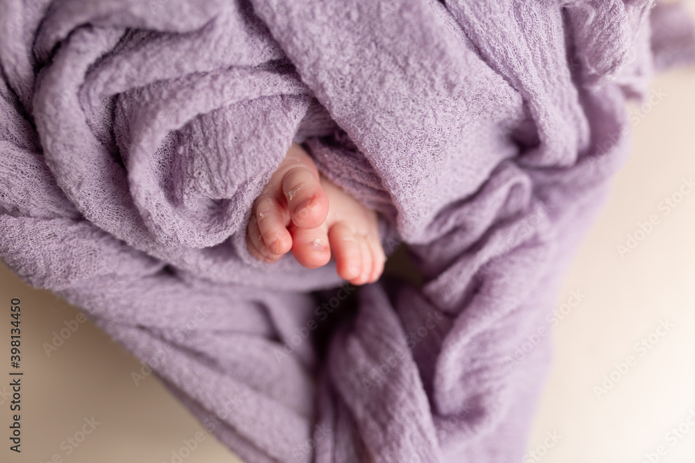 feet of a newborn baby. feet on a purple background. baby feet feet of a newborn baby. feet on a purple background. baby feet