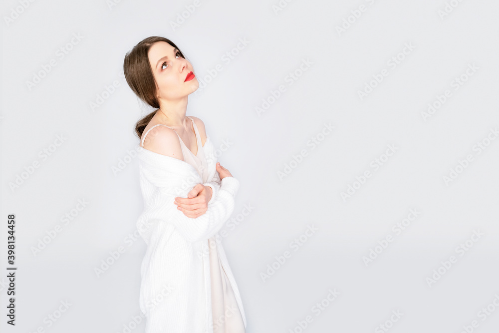 Girl all in white with red lips on an isolated white background. Girl posing in fashion style clothing.