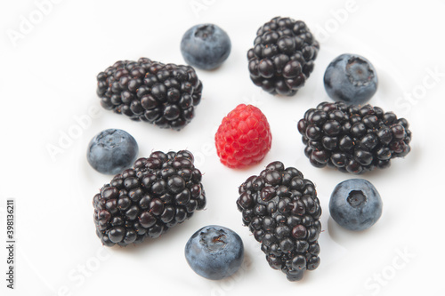 Assorted fresh different berries on a white plate. useful vitamin healthy food fruit. healthy vegetable breakfast