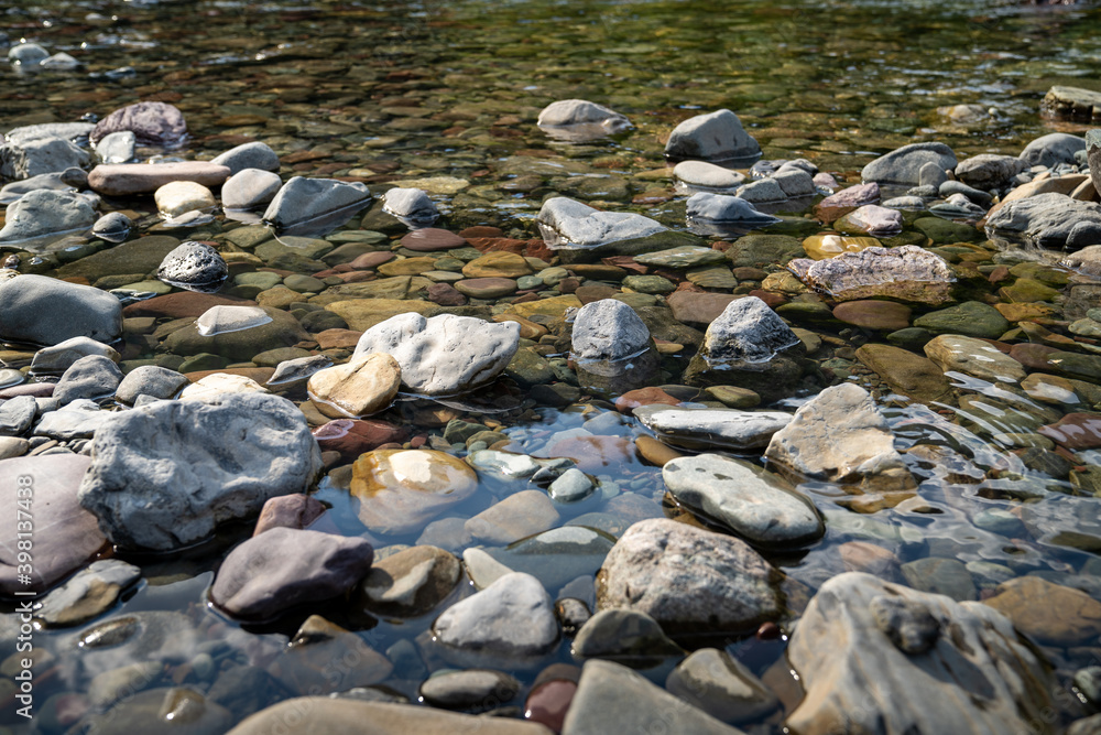 Pebbles and rocks in Avalanche Creek in Glacier National Park Montana. Selective focus Pebbles and rocks in Avalanche Creek in Glacier National Park Montana. Selective focus