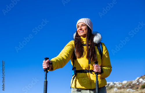 Portrait of a smiling young female hiking in the mountain.