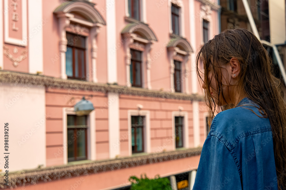 morning girl portrait with wet hair after shower profile face back to camera and old city architecture urban landmark view background space morning girl portrait with wet hair after shower profile face back to camera and old city architecture urban landmark view background space