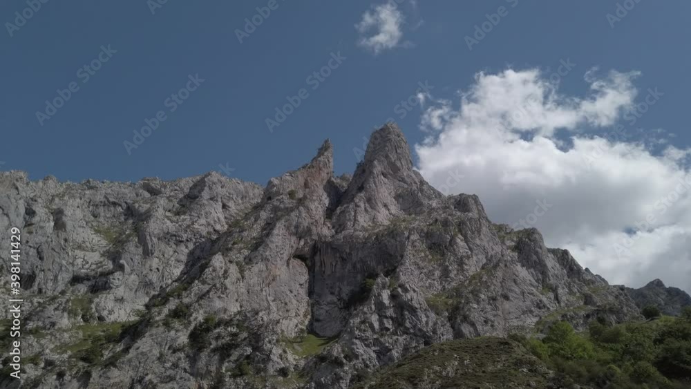 PAN SHOT - The Cares Route in the heart of Picos de Europa National Park, Cain-Poncebos, Asturias, Spain. Narrow and impressive canyon between cliffs, bridges, caves, footpaths and rocky mountains. PAN SHOT - The Cares Route in the heart of Picos de Europa National Park, Cain-Poncebos, Asturias, Spain. Narrow and impressive canyon between cliffs, bridges, caves, footpaths and rocky mountains.