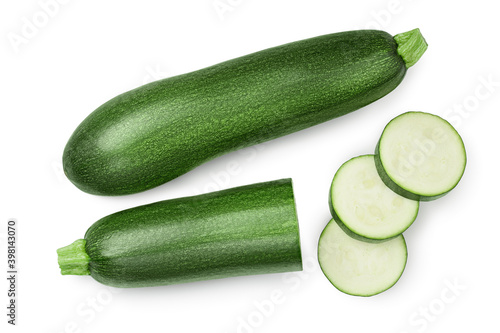 Fresh whole and sliced zucchini isolated on white background with clipping path and full depth of field. Top view. Flat lay