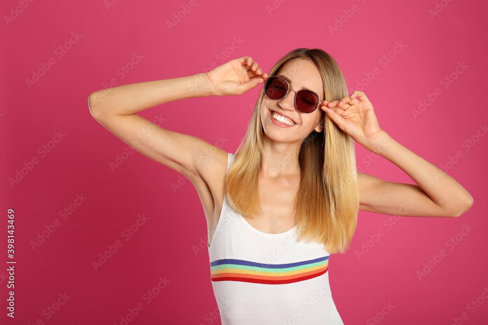 Beautiful woman in stylish sunglasses on pink background Beautiful woman in stylish sunglasses on pink background
