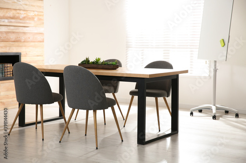 Modern meeting room interior with large table and chairs