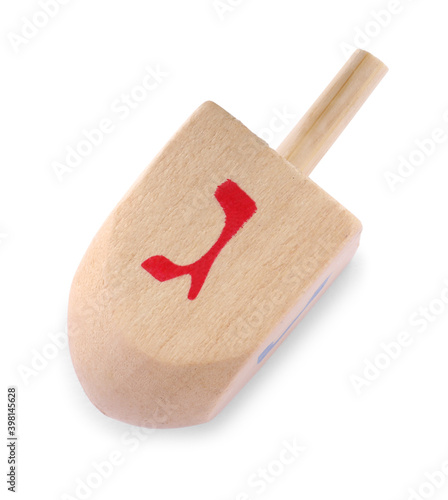 Wooden Hanukkah traditional dreidel with letter Gimel isolated on white, top view photo