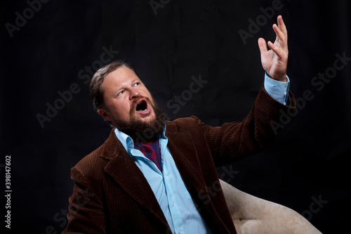 Stylish bearded man dressed in suit singing opera