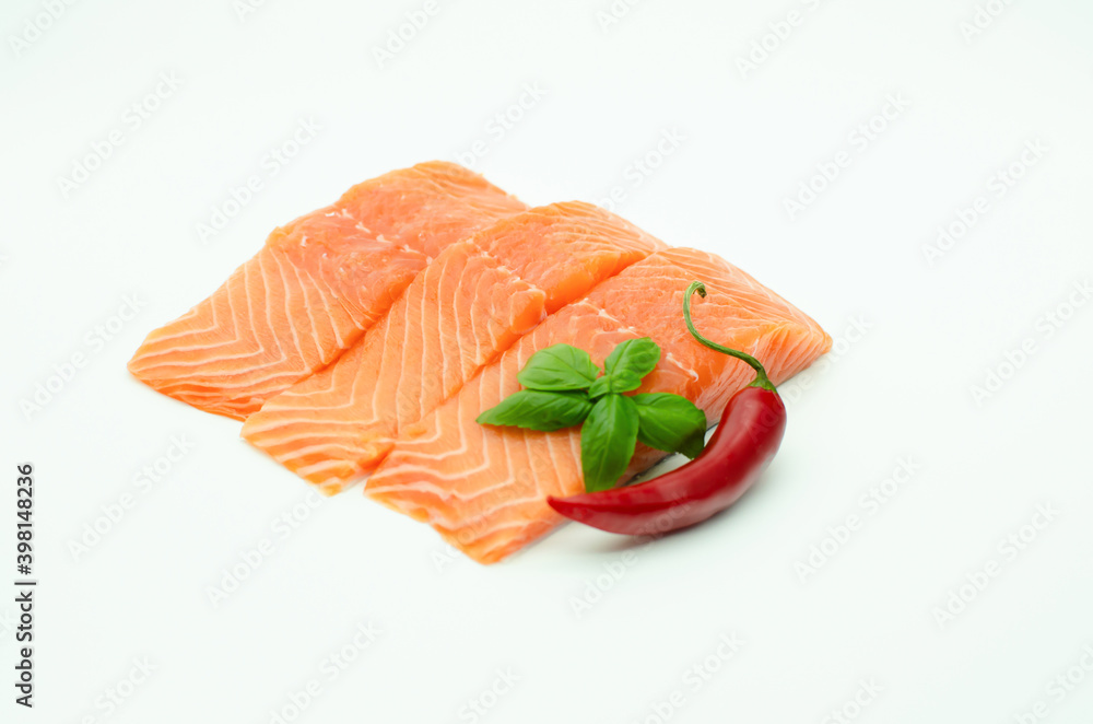 Pieces of fresh Salmon, red chilli pepper, lemon isolated on white Pieces of fresh Salmon, red chilli pepper, lemon isolated on white