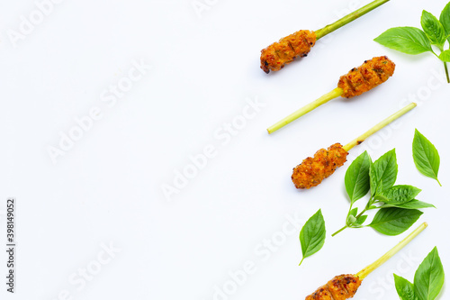 Grilled minced chicken with curry paste and coconut cream on lemongrass skewers. Top view