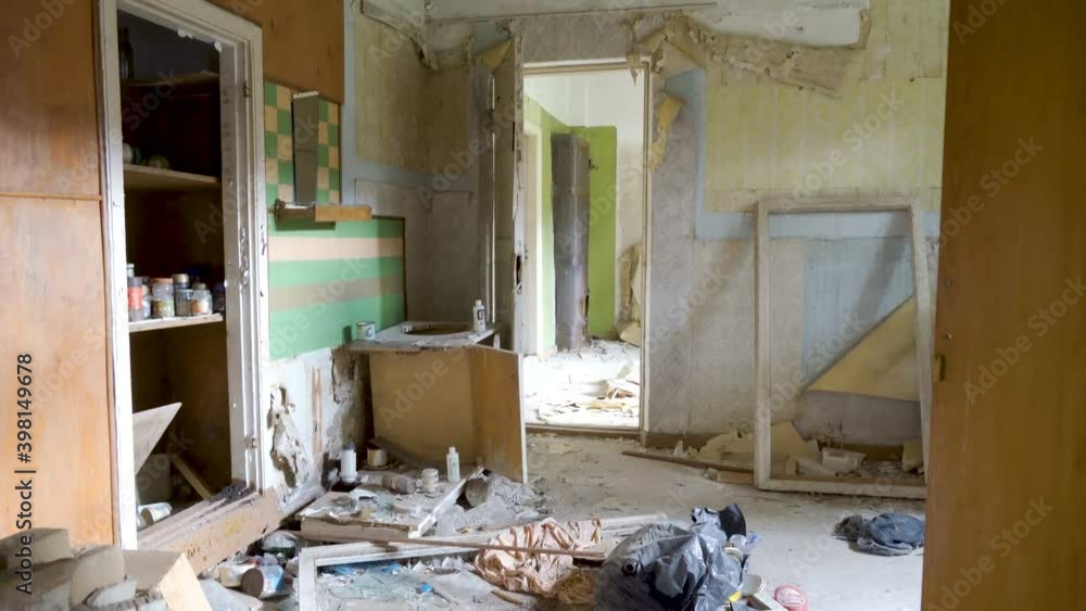 The mess inside the room of the abandoned house with lots of garbage on the floor in Estonia The mess inside the room of the abandoned house with lots of garbage on the floor in Estonia