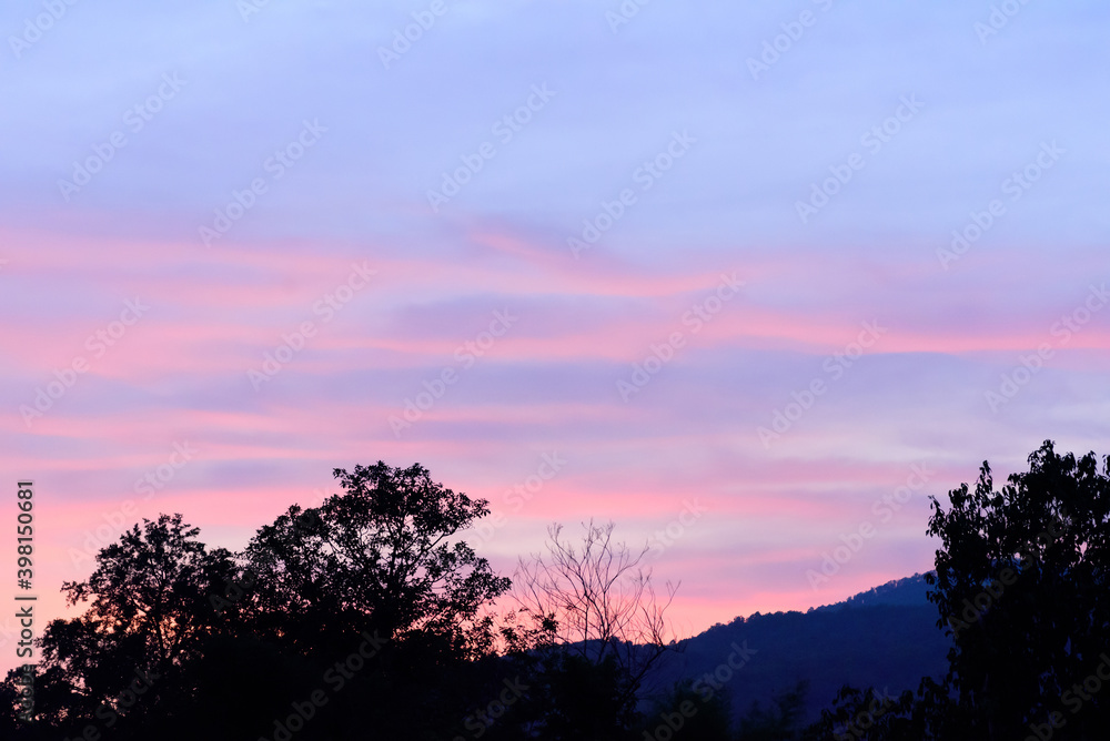 Beautiful twilight sky with cloud after sunset above the hill and trees